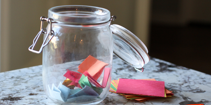 cristal jar with folder papers on it